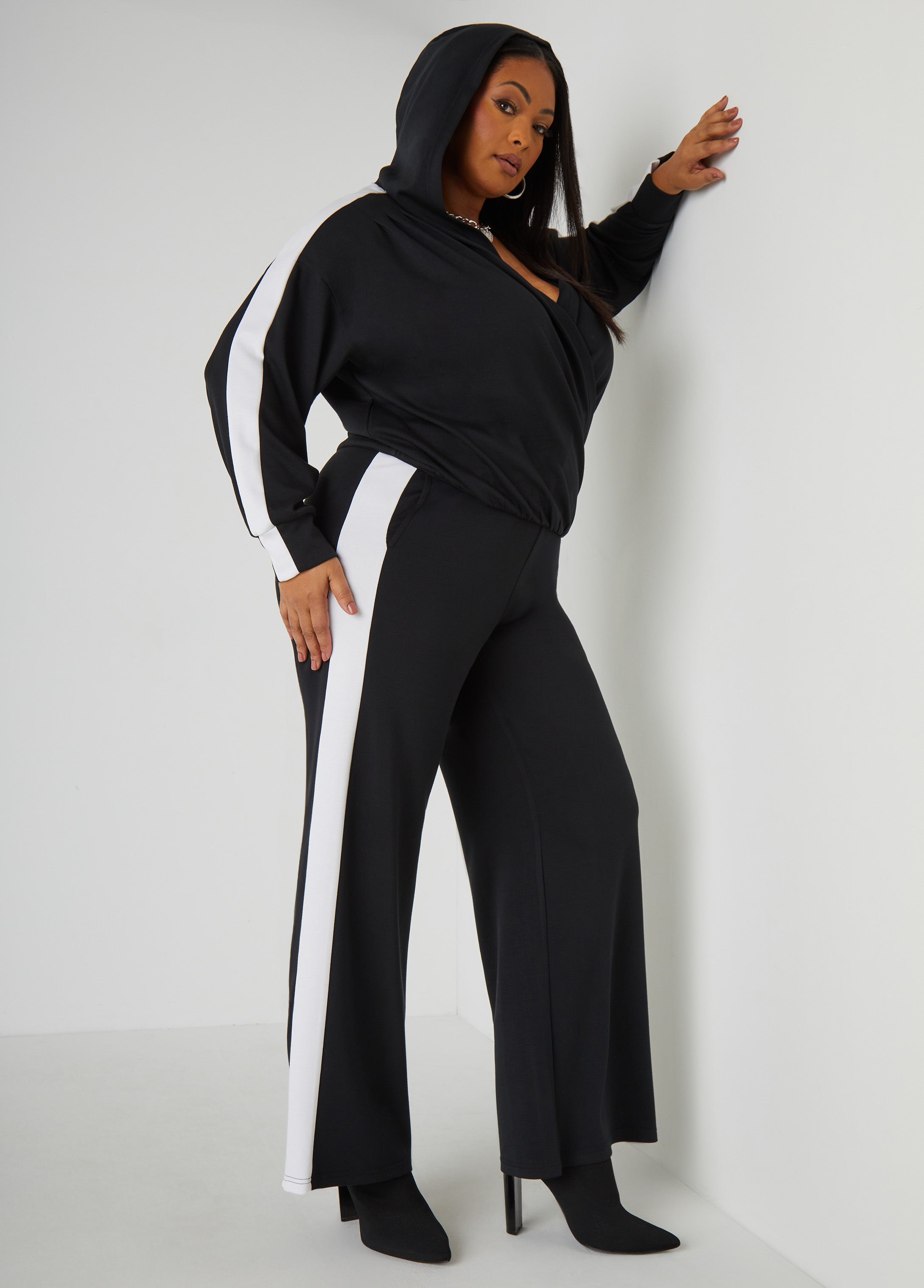 High-rise stretch-knit straight-leg track pants with two slit pockets at sides and striped trims. Pull-on style. Inseam: 31in. Can be worn as a two-piece set with matching top. Top sold separately.