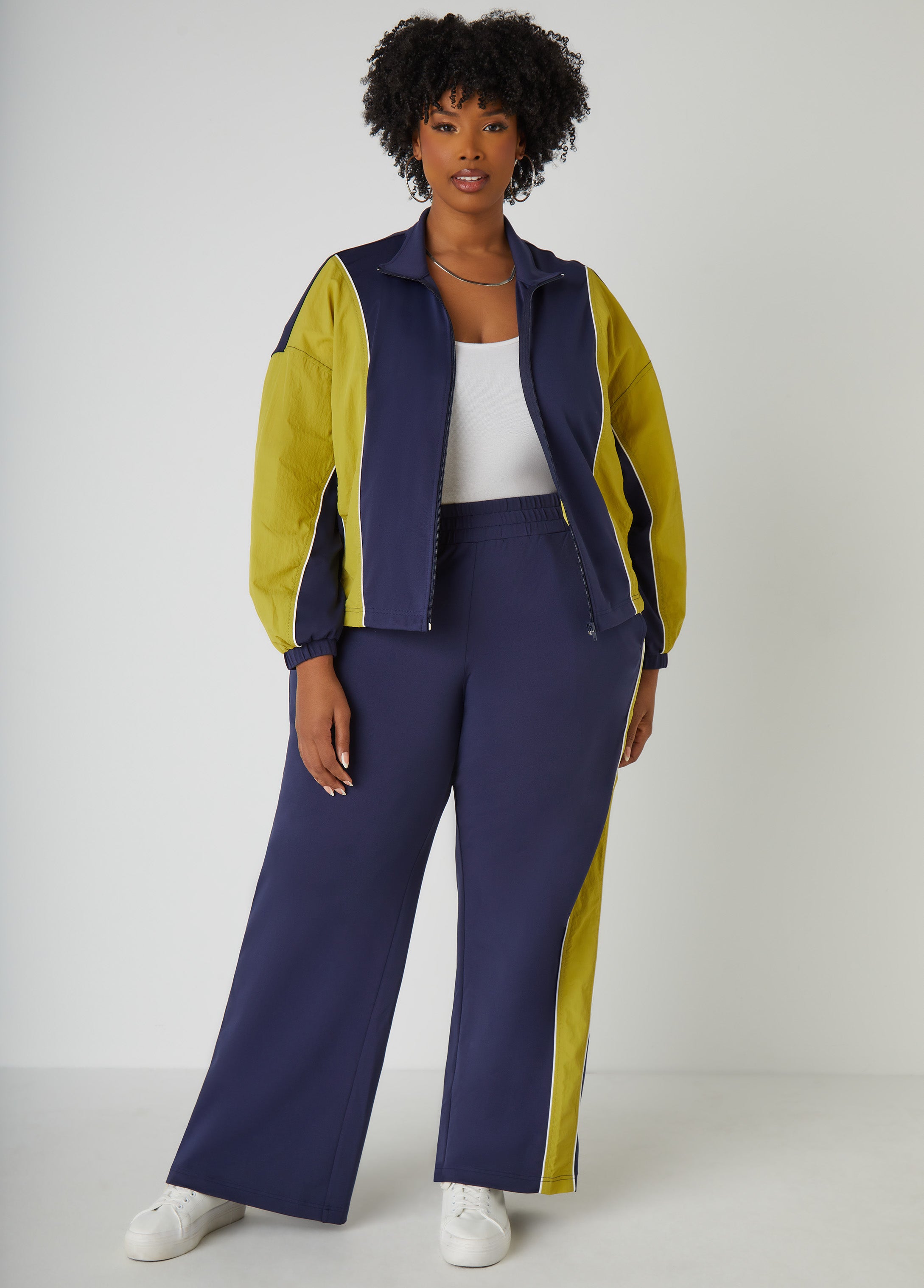 High-rise two-tone stretch-knit wide-leg pants with woven panels, piped trims, two slant pockets at sides and elasticized waistband. Pull-on style. Inseam: 32in. Can be worn as a two-piece set with matching pants. Pants sold separately.