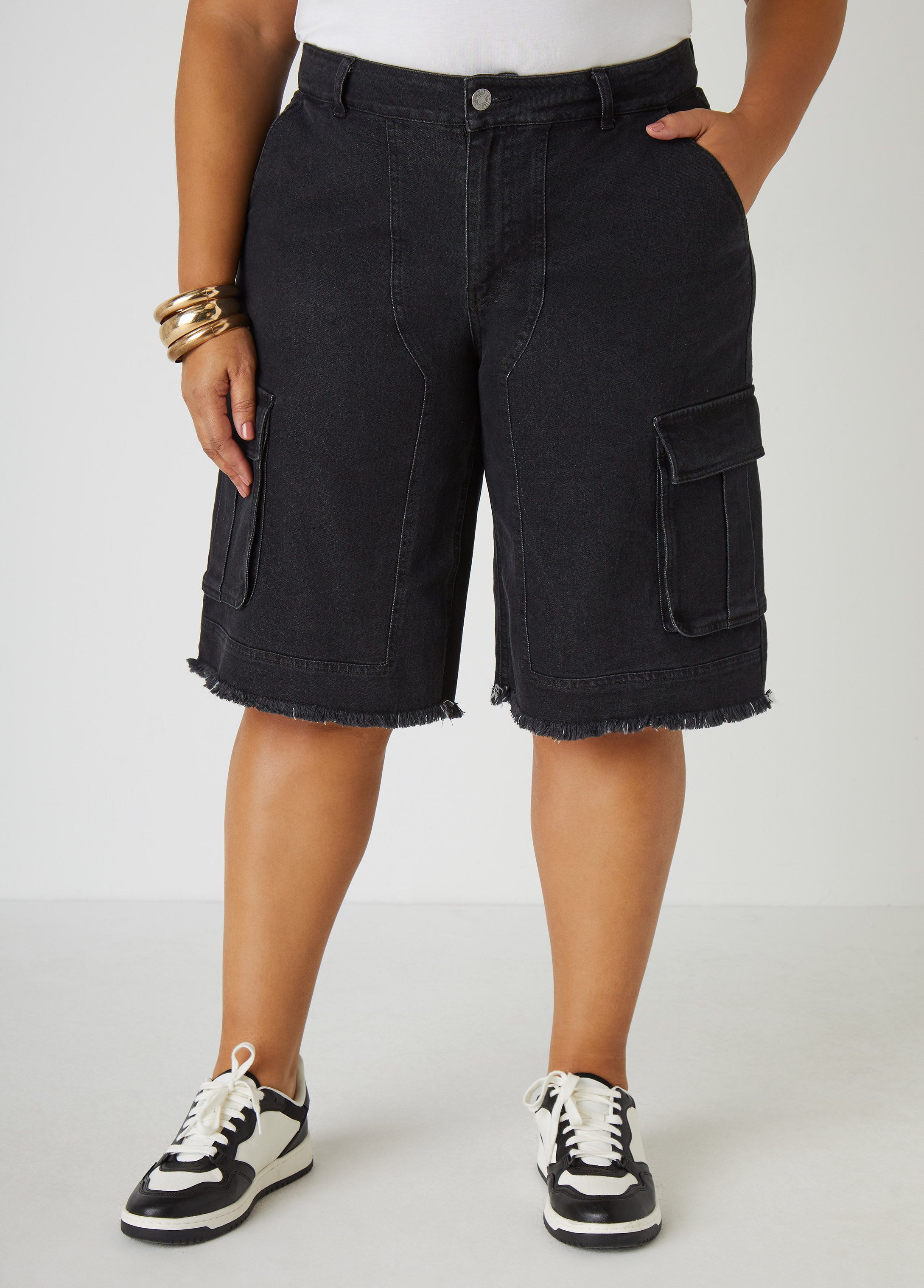 Mid-rise stretch-denim cargo Bermuda shorts with two cargo pockets at sides and frayed trims. Classic five pockets. Button and zip fastenings at front. Inseam: 13in.