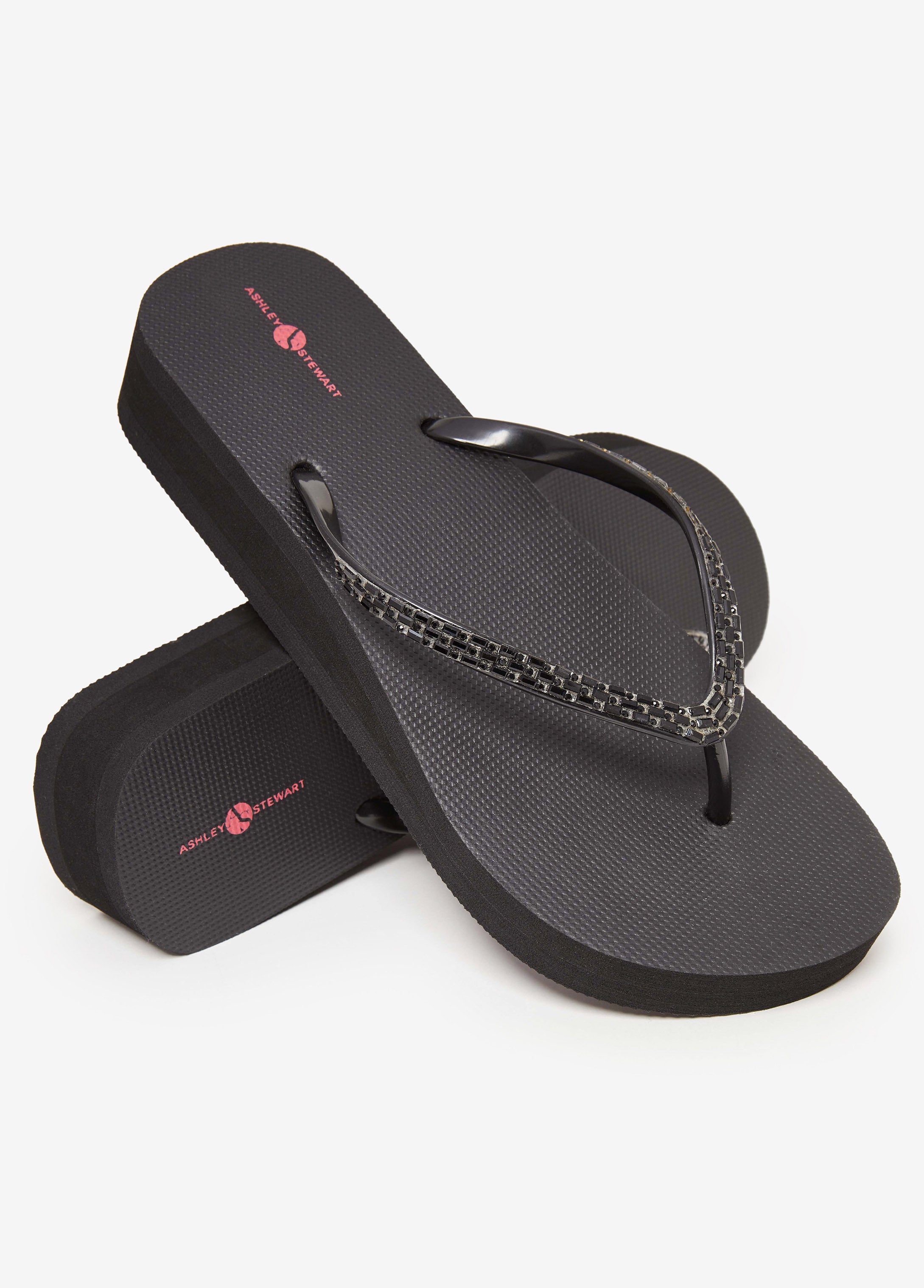 Round-toe flip flops thong strap, crystal embellishments and wedge heel. Slip-on style. Heel Height: 1.5in.